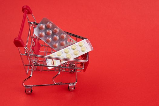 small trolley with medicines pharmacy shop pharmacy pills shopping. High quality photo