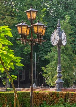 Ternopil, Ukraine 06.07.2021. Tripartite clock  on the Taras Shevchenko Boulevard in Ternopil, Ukraine, on a sunny summer morning