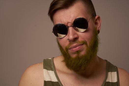 bearded man wearing sunglasses posing emotions isolated background. High quality photo
