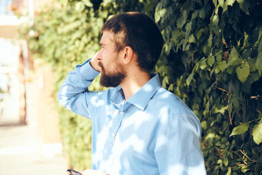 emotional man talking on the phone in the street. High quality photo