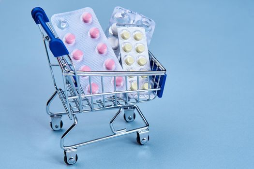 packs of pills in a trolley shopping in a pharmacy medicines. High quality photo
