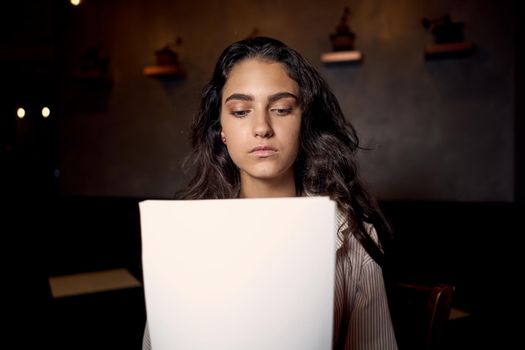 pretty woman in cafe in front of laptop working technology. High quality photo