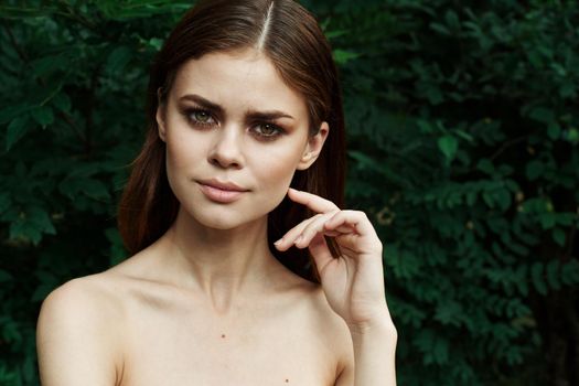 portrait of a woman in a field outdoors bare shoulders clear skin cropped view. High quality photo