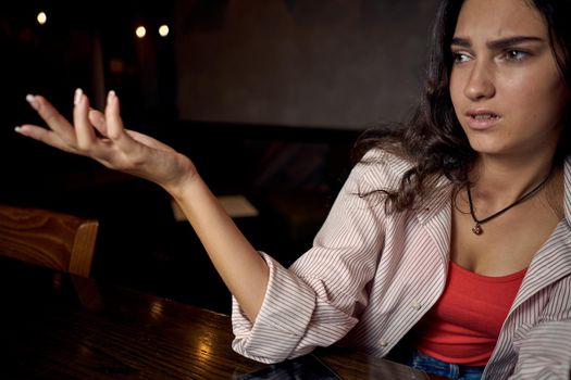 woman in a cafe at a table in front of a laptop device communication. High quality photo