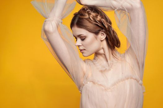 cheerful woman gesture hands cosmetics fashion hairstyle posing yellow background. High quality photo