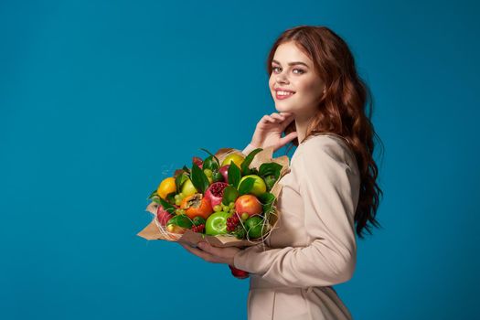 pretty woman beige coat fruit bouquet in hands isolated background. High quality photo