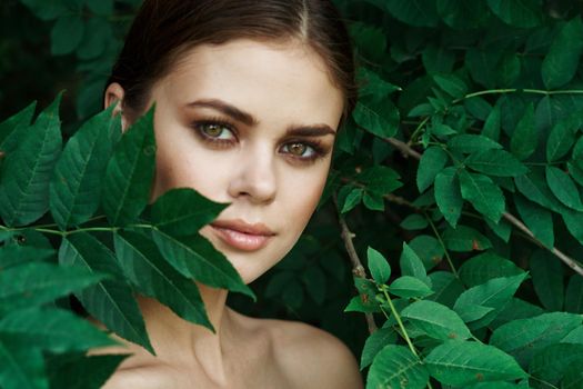 smiling woman green leaves clean skin nature summer model. High quality photo