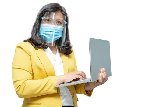 Asian business women use laptop notebook wearing mask and face shield on white background with clipping path, new normal to protect safety infection Covid-19 Coronavirus outbreak at office.