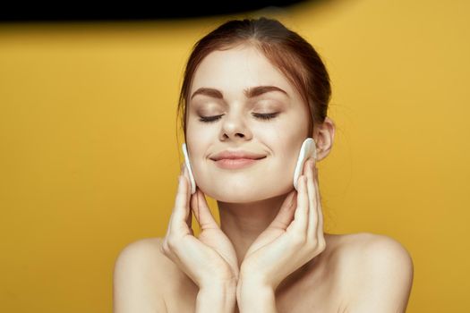 emotional women bare shoulders cotton pads and clear skin attractive look. High quality photo