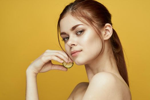 cheerful woman with cucumber vitamin skin care natural product. High quality photo