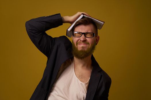 bearded man in a black jacket with a book in his hands education. High quality photo