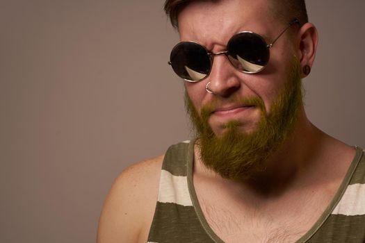 bearded man wearing sunglasses posing emotions isolated background. High quality photo