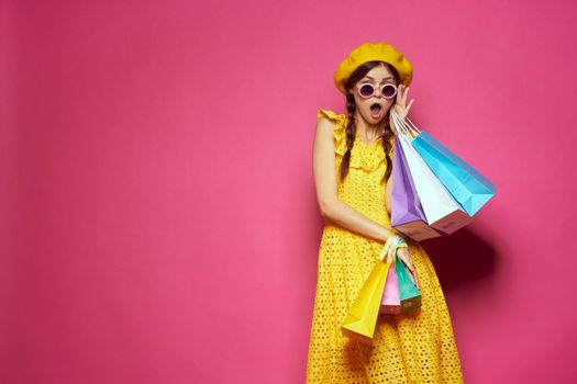 smiling woman in a yellow hat Shopaholic fashion style studio model. High quality photo