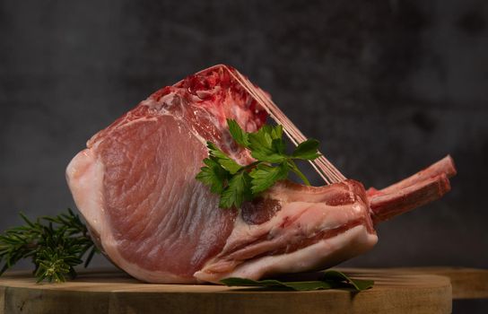 Pork ribs, Pork ribs with raw bone, Entrecote, Fresh and raw meats. Organic food, Meat with spices: pepper, salt, bay leaf, rosemary and its vegetables. High quality photo