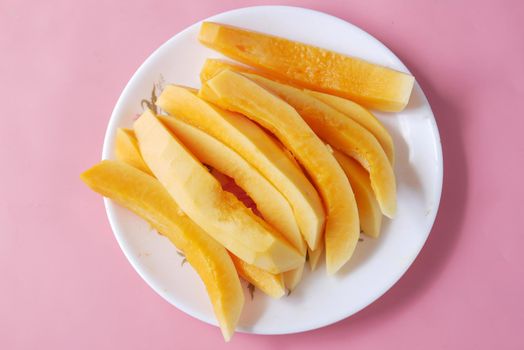 slice of papaya on white plate