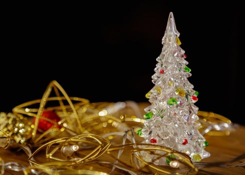 Christmas new year boxes with surprise and red bow. Yellow garland, lights in a dark room.