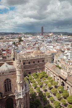 Aerial view of the Cathedral of Saint Mary of the See (Seville Cathedral) in Seville, Andalusia, Spain in a sunny and cloudy day