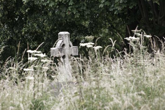 A Graveyard with cross shaped headstone isolation loneliness