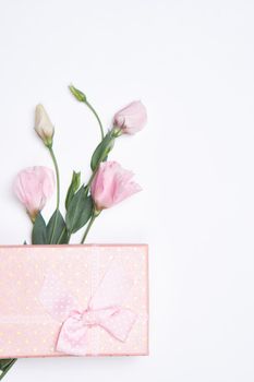 pink gift box flower bouquet holiday light background. High quality photo