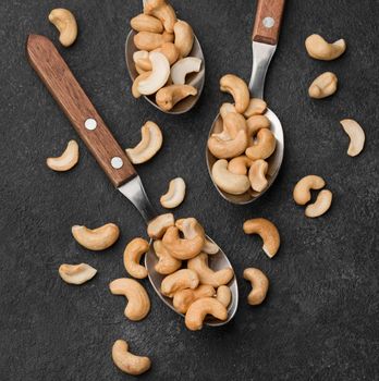 close up spoons filled with healthy raw cashew nuts. High resolution photo