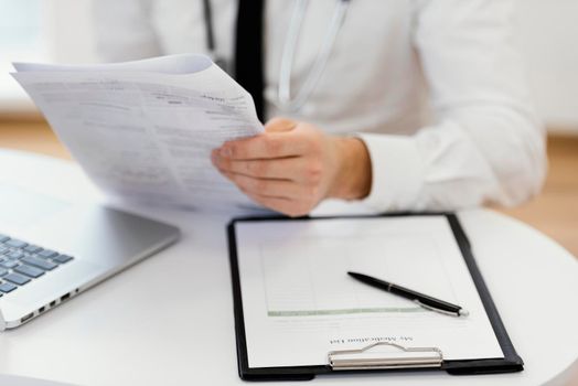 close up doctor holding medical records. High resolution photo