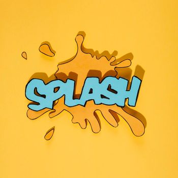 blue splash text blot against yellow background. High resolution photo