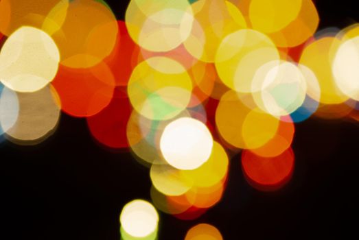 colored blurred bokeh christmas garlands on dark background