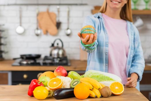 close up smiley girl holding up apple. High resolution photo