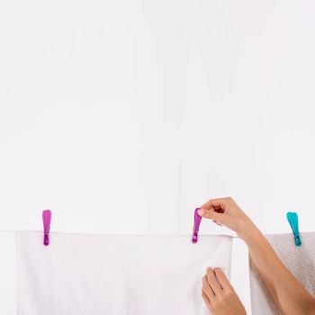 close up woman taking towels clothesline. High resolution photo