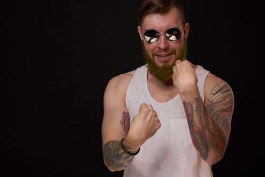 bearded macho man in white t-shirt sunglasses fashion tattoos. High quality photo