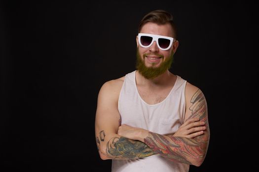 bearded macho man in white t-shirt sunglasses fashion tattoos. High quality photo