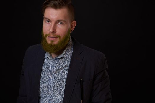 fashionable business man in a jacket with a beard posing. High quality photo