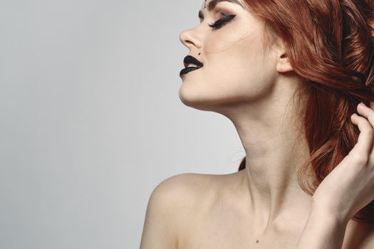 red-haired woman with bare shoulders bright makeup base zodiac sign horoscope. High quality photo