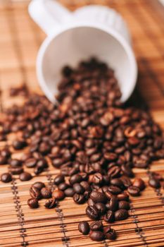 coffee beans Hot drink spilled grains wooden table. High quality photo