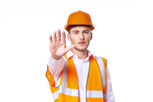 working man in orange uniform posing construction. High quality photo