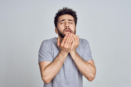 bearded man in white t-shirt posing gesturing with his hands. High quality photo