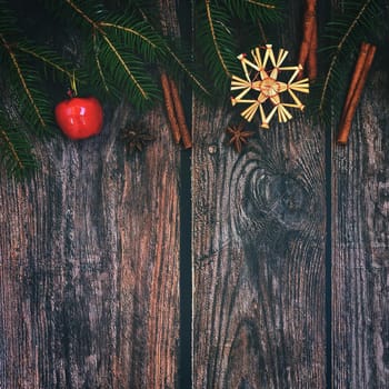 Christmas background with decorations on a brown wooden background. Flat lay, top view with copy space.