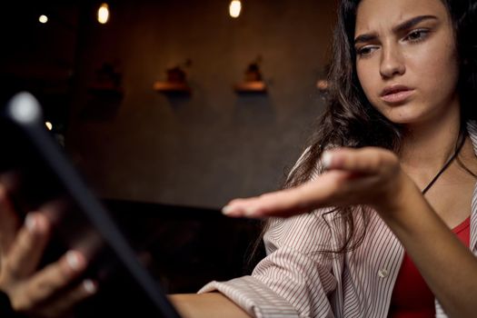 woman sitting in a cafe in front of a laptop communication technology internet. High quality photo