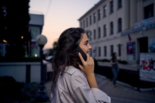 woman with phone in her hands outdoors walk lifestyle summer. High quality photo