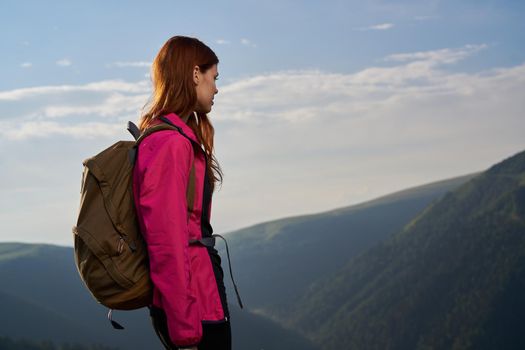 woman hiker outdoors in the mountains landscape fresh air. High quality photo
