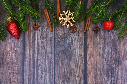 Christmas background with decorations on a brown wooden background. Flat lay, top view with copy space.