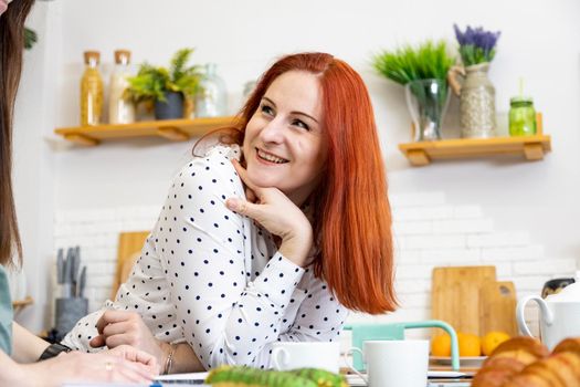 portrait of happy beautiful caucasian woman laughing in the kitchen