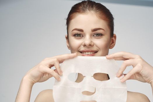 woman with mask in hands skin care rejuvenation spa treatments. High quality photo