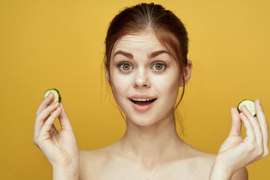 cheerful woman with cucumber vitamin skin care natural product. High quality photo