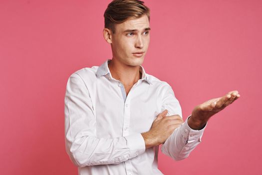 handsome man posing white shirt fashion self confidence pink background. High quality photo