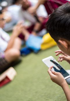 BANGKOK THAILAND - April 19,2018 Many Serious children playing on smartphone, Children playing on smartphone during the brake time in school