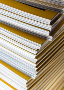 Stack of yellow color monthly magazine