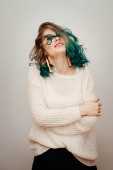 Happy woman with colored hair on a white background. Turquoise hair.