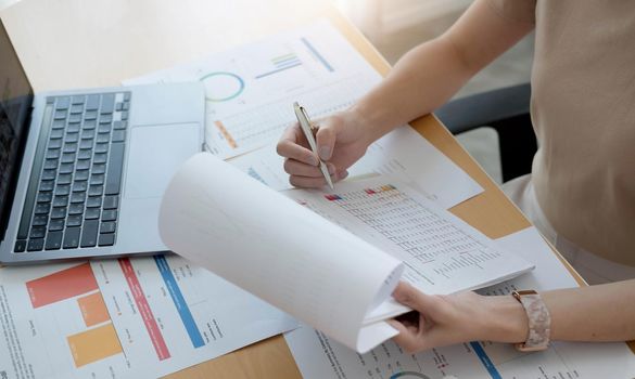 close up woman working with graph data at office, financial report concept..