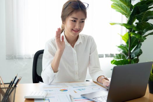 Close up Businesswoman using calculator and laptop for calaulating finance, tax, accounting, statistics and analytic research concept